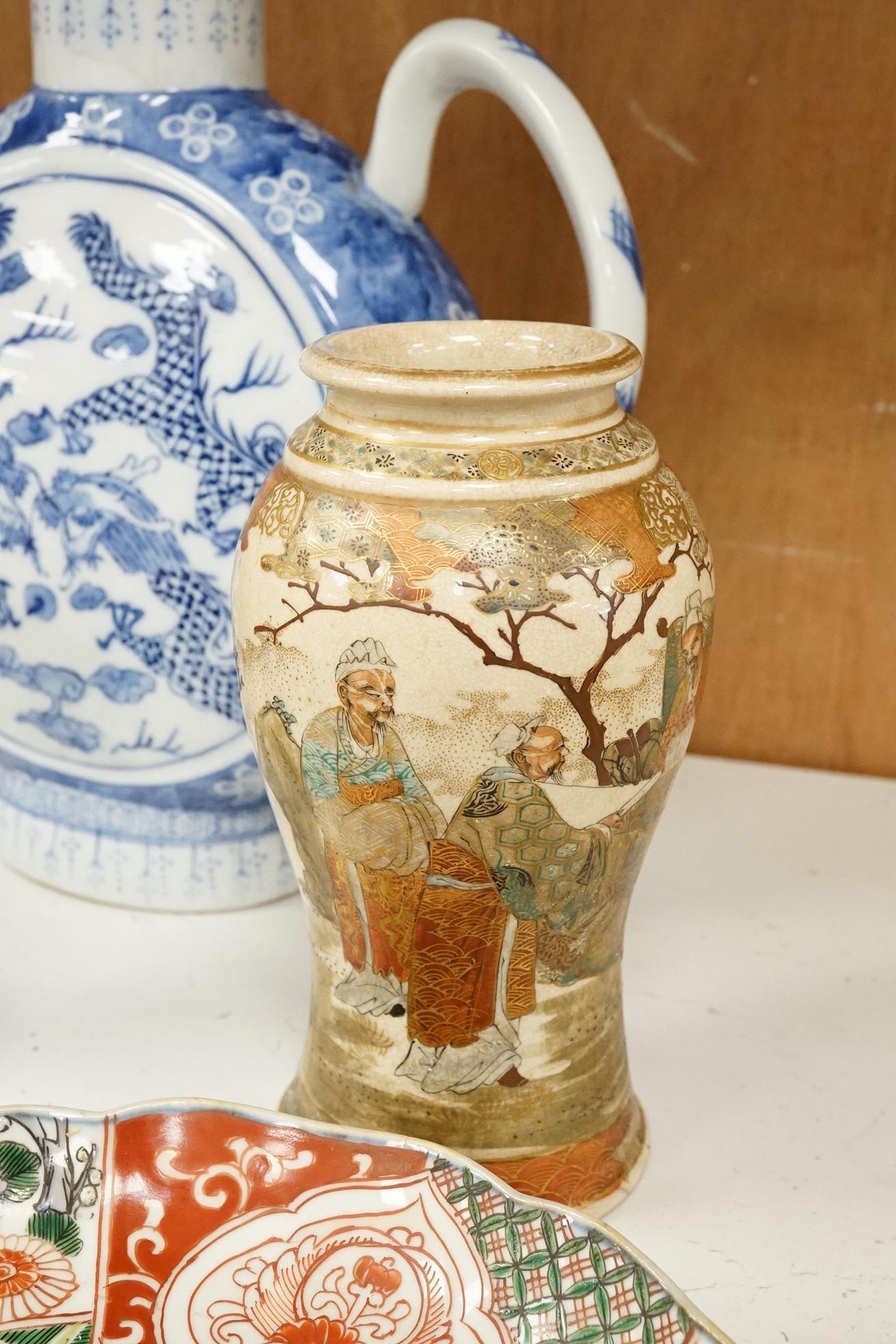 A group of mixed oriental porcelain and metalware to include a Japanese satsuma vase, cinnabar lacquer vase and blue and white teapot, largest 32cm high.